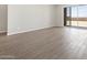 Open-concept living area with sliding glass doors and tile flooring. Ready for your personal touch at 17561 W Pierson St, Goodyear, AZ 85395