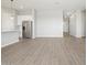 The living space features tile flooring, a stainless steel refrigerator, and an open concept design at 17561 W Pierson St, Goodyear, AZ 85395