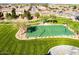 Community basketball court surrounded by lush green lawns and landscaping at 196 W Yellow Wood Ave, San Tan Valley, AZ 85140