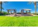 Tranquil community gathering space with pergola, seating, and well-manicured lawns at 196 W Yellow Wood Ave, San Tan Valley, AZ 85140