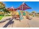 Community playground with slides, climbing structures, and ample shade at 196 W Yellow Wood Ave, San Tan Valley, AZ 85140