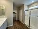 Bathroom with double sinks, a glass-enclosed shower, and a view into the closet at 2945 S 232Nd Dr, Buckeye, AZ 85326
