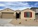 Charming single-story home with a two-car garage, desert landscaping, and red shutters at 2945 S 232Nd Dr, Buckeye, AZ 85326
