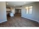 Open living space with wood-look floors connecting the kitchen and dining areas at 2945 S 232Nd Dr, Buckeye, AZ 85326