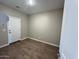Small office area with tile flooring, neutral walls, and a solid-core door at 2945 S 232Nd Dr, Buckeye, AZ 85326