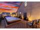 Inviting backyard featuring a luxurious spa and cozy seating area with a vibrant sunset backdrop at 31069 N 138Th Ave, Peoria, AZ 85383