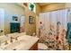 Cozy bathroom with a white shower curtain, vanity, and neutral tones at 41814 N Crooked Stick Rd, Anthem, AZ 85086