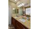 Bathroom showcasing double sinks, wood cabinetry, and a full width mirror for a polished and functional space at 41814 N Crooked Stick Rd, Anthem, AZ 85086