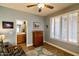 Bedroom featuring shuttered windows, ceiling fan, wood-look floors, and light blue painted walls at 41814 N Crooked Stick Rd, Anthem, AZ 85086