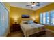 Comfortable bedroom with neutral-toned walls, ceiling fan and bright natural light, creating a restful atmosphere at 41814 N Crooked Stick Rd, Anthem, AZ 85086