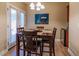 Cozy dining room with a wooden table and doors to the outside, perfect for casual and Gathering meals at 41814 N Crooked Stick Rd, Anthem, AZ 85086