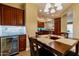 Open dining room featuring a wine fridge and dark wooden table, making it perfect for entertaining guests at 41814 N Crooked Stick Rd, Anthem, AZ 85086