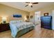 Serene primary bedroom with a ceiling fan and access to the en-suite bathroom at 41814 N Crooked Stick Rd, Anthem, AZ 85086