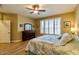 Bright primary bedroom with a ceiling fan, large window and tile floors at 41814 N Crooked Stick Rd, Anthem, AZ 85086