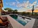 Backyard pool with a spa, lounge chairs, and desert landscaping at 41814 N Crooked Stick Rd, Anthem, AZ 85086