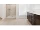 Stylish bathroom features a glass walk-in shower, soaking tub, and a double vanity with modern hardware at 4348 W Hannah St, San Tan Valley, AZ 85144