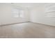 Bright bedroom with neutral colors, tiled floors, and large windows offering plenty of natural light at 4348 W Hannah St, San Tan Valley, AZ 85144