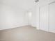 Spacious bedroom features neutral carpet, bright white walls, and a double closet with sliding doors at 4348 W Hannah St, San Tan Valley, AZ 85144