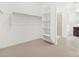 Spacious walk-in closet features carpet floors, built-in shelving and hanging racks for optimal organization at 4348 W Hannah St, San Tan Valley, AZ 85144