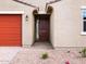Close-up of the home's entrance featuring a six-panel front door, brick walkway, and low-maintenance desert landscaping at 4348 W Hannah St, San Tan Valley, AZ 85144