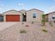 Well-maintained single-story home featuring a red garage door and a neatly landscaped front yard with desert flora at 4348 W Hannah St, San Tan Valley, AZ 85144