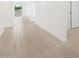 Bright hallway featuring neutral walls and modern wood-look tile flooring throughout the home's open layout at 4348 W Hannah St, San Tan Valley, AZ 85144