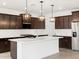 New kitchen featuring an island, stainless steel appliances, and dark cabinets at 4348 W Hannah St, San Tan Valley, AZ 85144