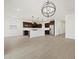 Open-concept kitchen with a white island, stainless steel appliances, and modern lighting fixtures at 4348 W Hannah St, San Tan Valley, AZ 85144