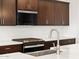 Modern kitchen featuring stainless steel appliances, white subway tiles and dark cabinetry at 4348 W Hannah St, San Tan Valley, AZ 85144