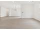 Open-concept living area with neutral colors, modern flooring, and contemporary lighting fixtures at 4348 W Hannah St, San Tan Valley, AZ 85144