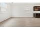 Bright living room with light-toned floors, a large window with blinds, and a minimalist aesthetic at 4348 W Hannah St, San Tan Valley, AZ 85144