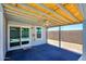 Covered back patio with ceiling fan and sliding doors at 11501 W Charter Oak Rd, El Mirage, AZ 85335