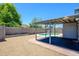 Large backyard featuring a covered patio, gravel landscaping and a pool, offering a private and relaxing outdoor space at 11501 W Charter Oak Rd, El Mirage, AZ 85335