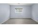 Cozy bedroom with gray wood floors and blue paint at 11501 W Charter Oak Rd, El Mirage, AZ 85335