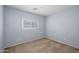 Bedroom with carpeted floors, blue paint and a window at 11501 W Charter Oak Rd, El Mirage, AZ 85335