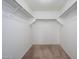 Walk-in closet with carpet floors and rods for ample storage at 11501 W Charter Oak Rd, El Mirage, AZ 85335