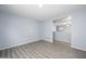 Open living room with gray wood floors and blue paint at 11501 W Charter Oak Rd, El Mirage, AZ 85335