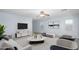 Stylishly furnished living room with contemporary decor, neutral colors, ceiling fan and ample natural light at 11501 W Charter Oak Rd, El Mirage, AZ 85335