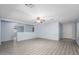 Open living room with gray wood floors, a ceiling fan, and blue paint at 11501 W Charter Oak Rd, El Mirage, AZ 85335