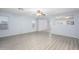 Large living room features wood floors and a ceiling fan at 11501 W Charter Oak Rd, El Mirage, AZ 85335