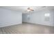 Bright and airy living room with modern flooring, ceiling fan and multiple windows, perfect for comfortable living at 11501 W Charter Oak Rd, El Mirage, AZ 85335