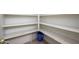 Walk-in pantry with multiple white shelves offering ample storage space for kitchen supplies at 11501 W Charter Oak Rd, El Mirage, AZ 85335