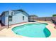 Inviting backyard pool with patio cover and a basketball hoop, perfect for outdoor fun at 11501 W Charter Oak Rd, El Mirage, AZ 85335