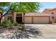 Charming single-Gathering home showcasing a large shade tree and a wide driveway with a 3-car garage at 1631 E Carla Vista Dr, Chandler, AZ 85225