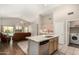 Bright open kitchen features an island with seating and stainless appliances with views to the living room at 1631 E Carla Vista Dr, Chandler, AZ 85225