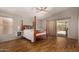 Spacious main bedroom with wood floors, a ceiling fan, and access to the backyard at 1631 E Carla Vista Dr, Chandler, AZ 85225