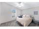 Cozy bedroom with a comfortable bed, ceiling fan, and a window offering natural light at 201 S Greenfield Rd # 51, Mesa, AZ 85206