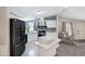Bright kitchen with white cabinets, black appliances, and an island perfect for food preparation at 201 S Greenfield Rd # 51, Mesa, AZ 85206