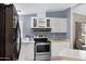 Charming kitchen with white cabinetry, stainless steel appliances, and plenty of counter space at 201 S Greenfield Rd # 51, Mesa, AZ 85206