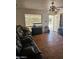 Cozy living room with a ceiling fan, a window, and wood floors at 3820 W Encanto Blvd, Phoenix, AZ 85009